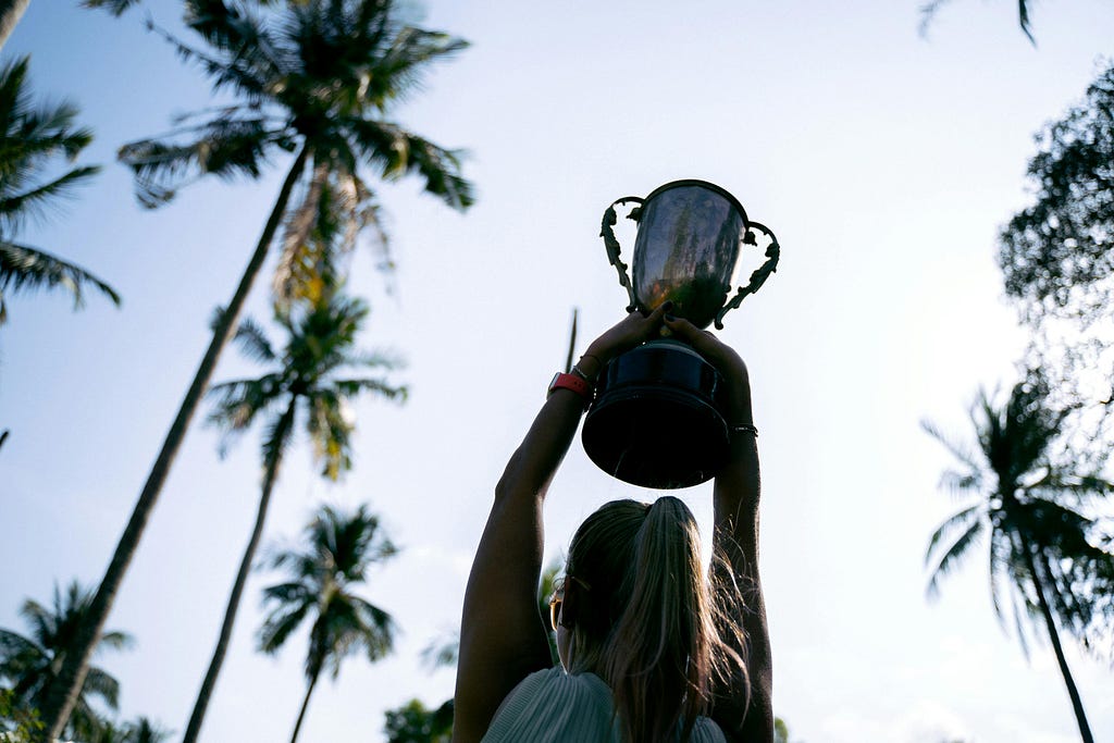 A woman holding a trophy