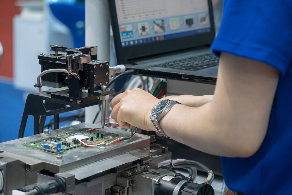 Engineer uses probing machine to measure different points of a PCB. PCB testing is necessary to ensure a higher quality product