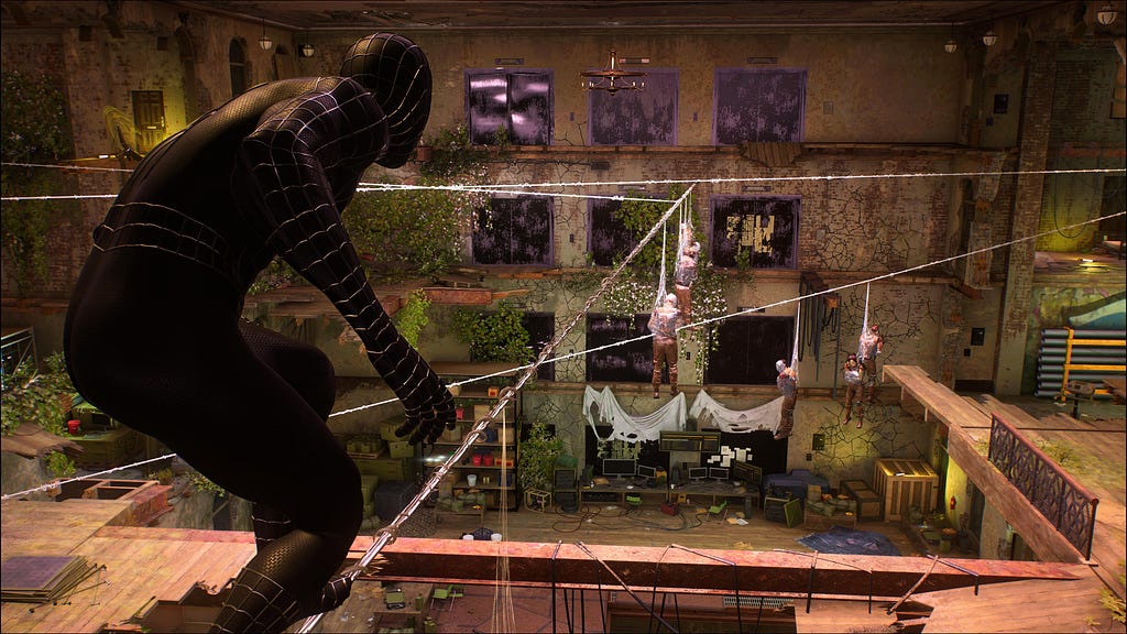 Inside a warehouse, Spider-Man stands on a webline created by attaching webs between two points. Enemies hang from the weblines.