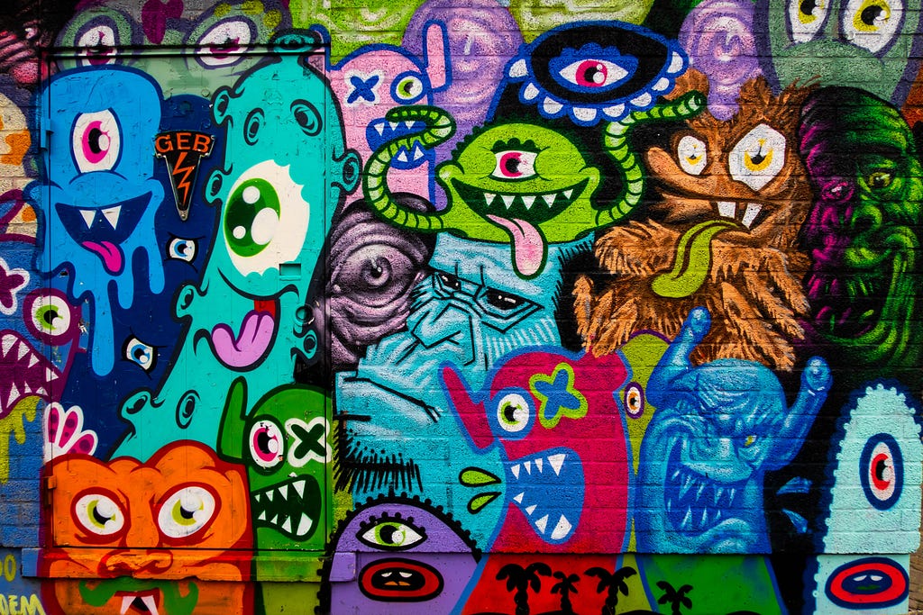 Strange creatures graffiti on the brick wall