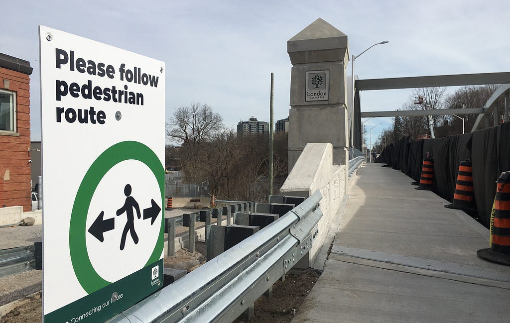 sign announcing pedestrian route across new bridge