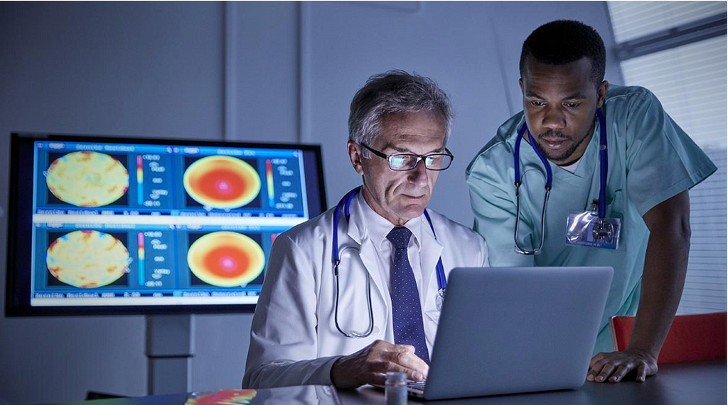 Doctors looking at a computer screen with a stern face