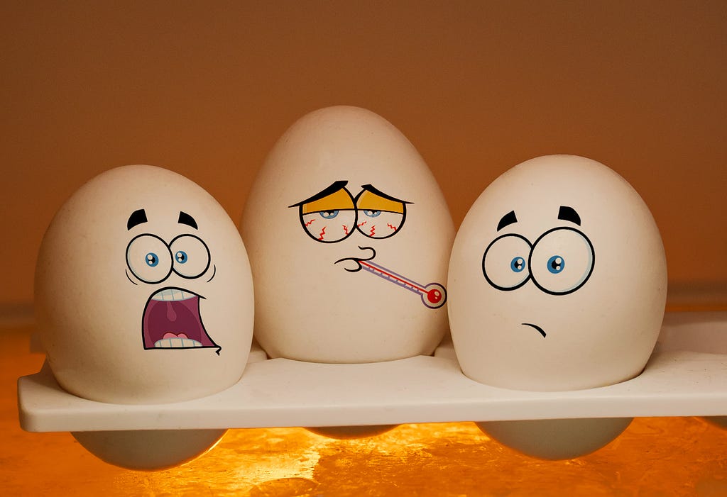 Eggs etched with facial expressions over their shells