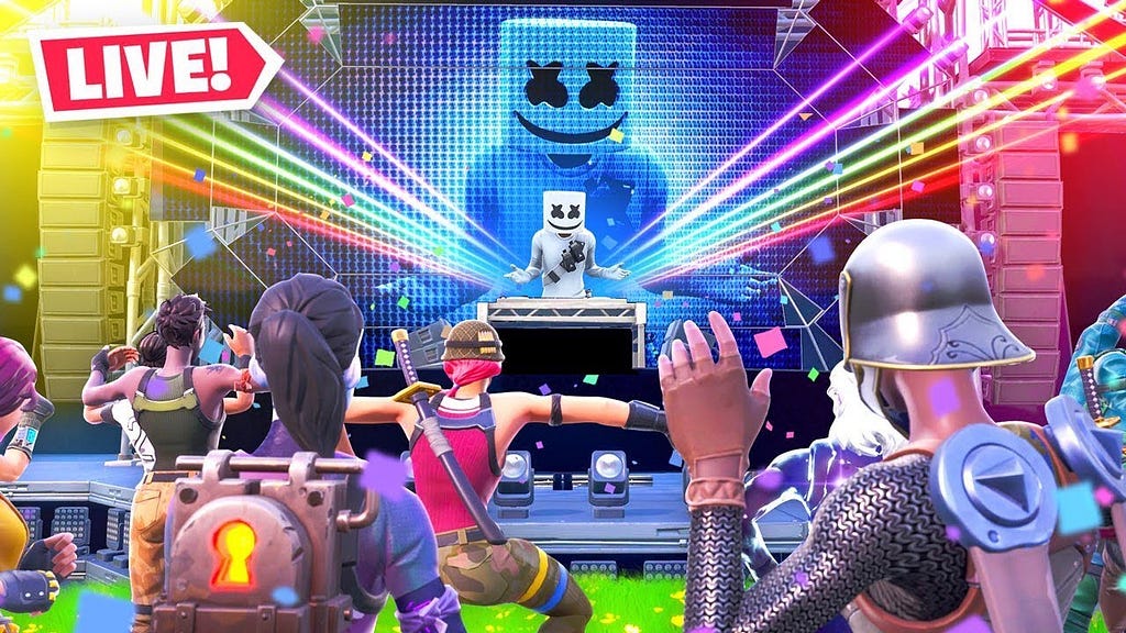 Artist Marshmello on stage with DJ deck and lights shining out with several avatars watching and dancing