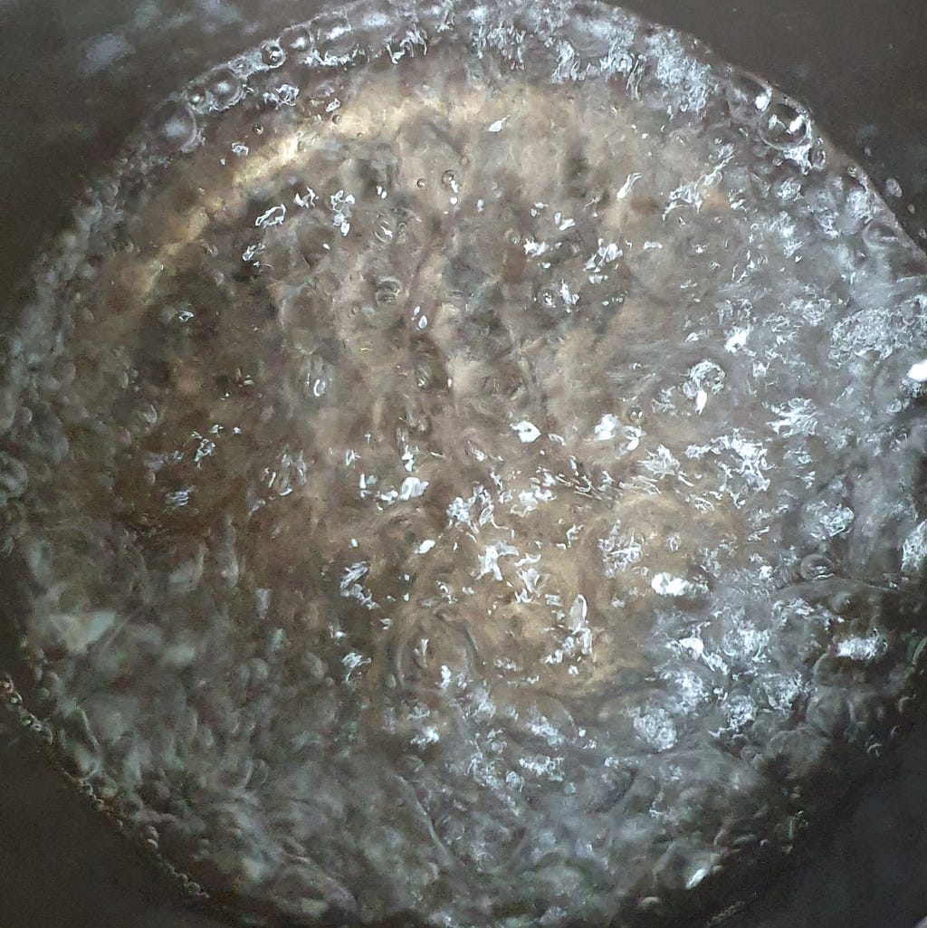 Around 450ml (2 cups) of water boiling for a package of Wicked Ramen (Yogoe Ramyeon) Vongole Flavor.