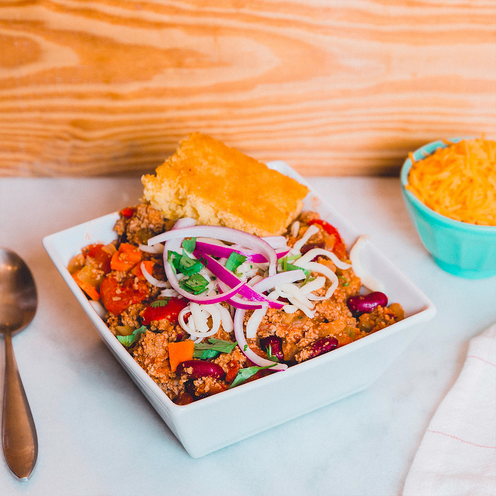 A bowl of chili with cornbread