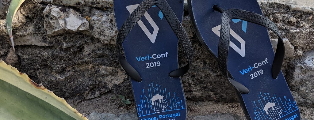 Verifa-branded flip-flops against stone background