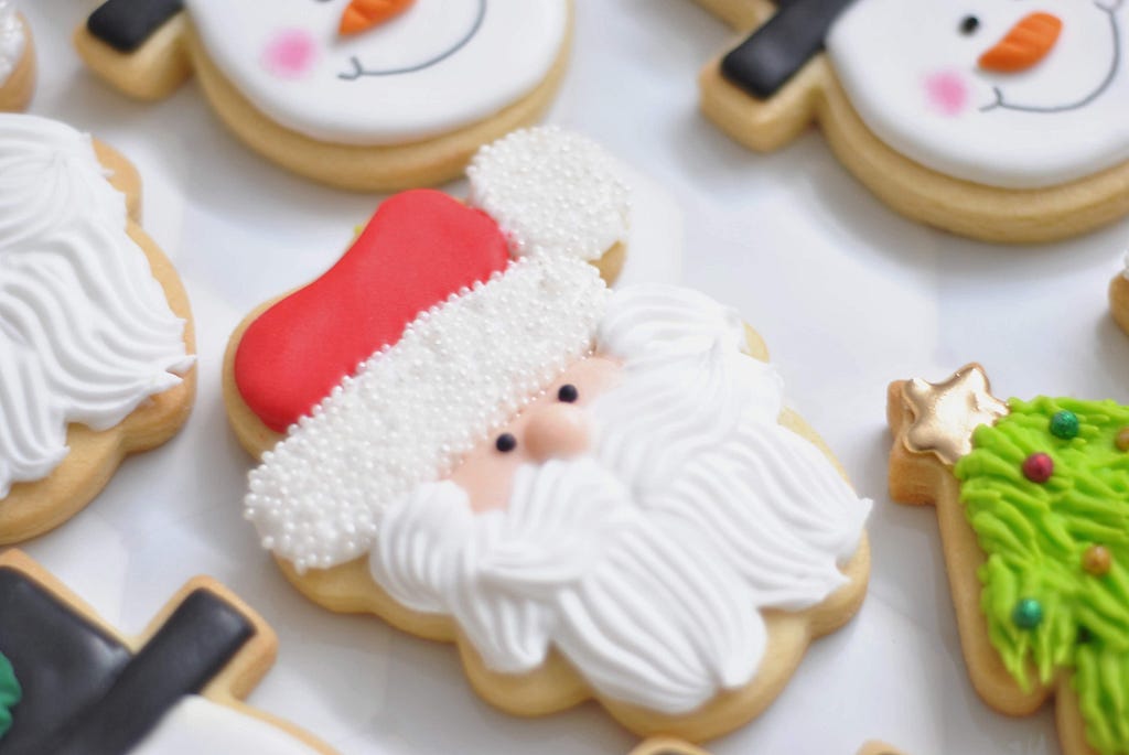 Close up of sugar cookie that depicts santa claus.