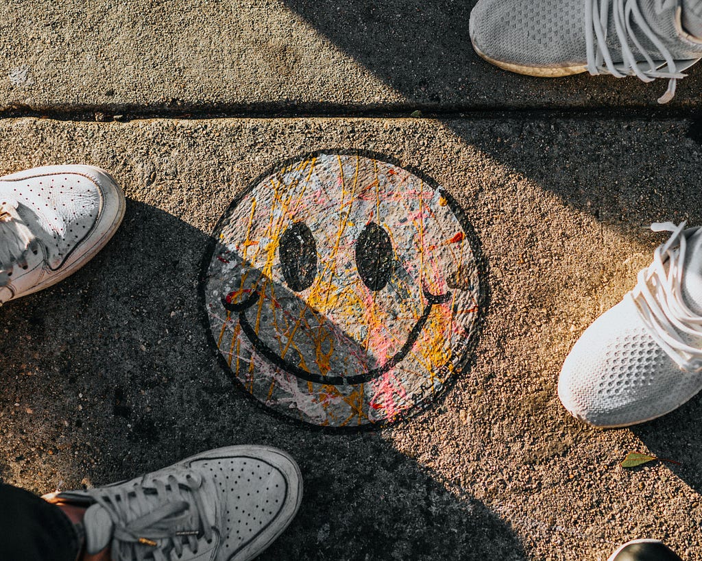 Smiley painted on the concrete of a street