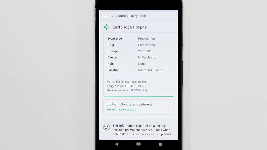 A photograph of a fictional service on a mobile phone. The service is for Eastbridge Hospital, and it shows information that is logged as part of a tamper proof history.
