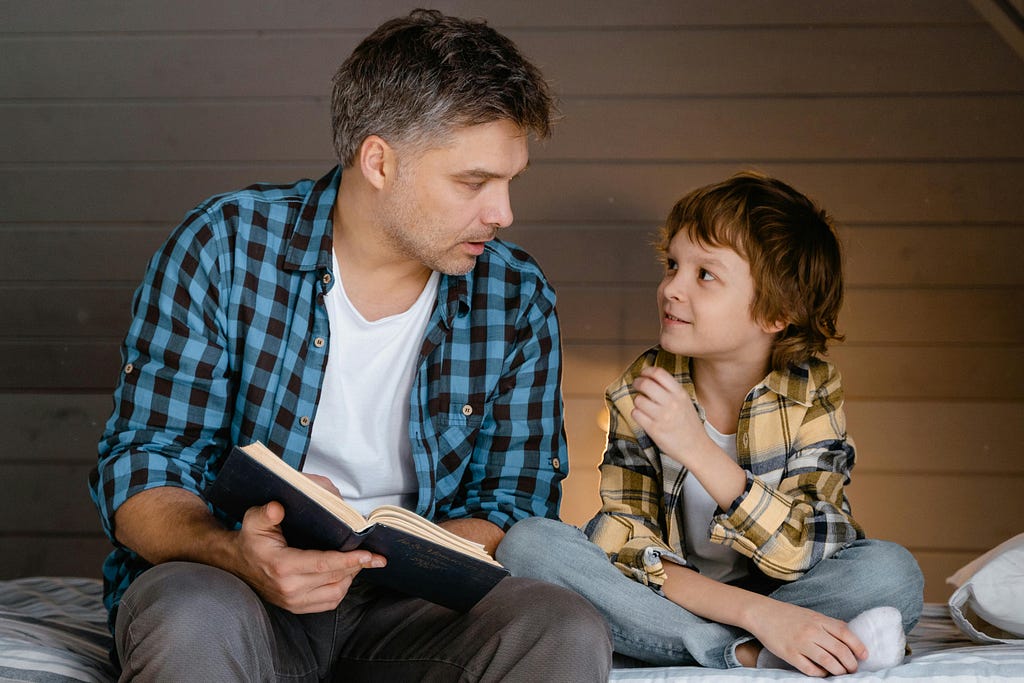 A father reading a small boy a story