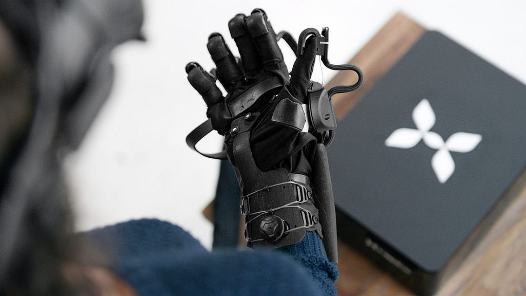 Woman wearing HaptX brand haptic gloves for VR and telerobotics.