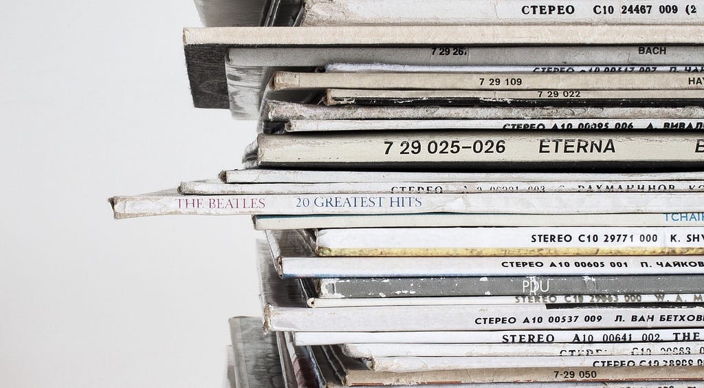 Photograph of a stack of vinyl records, showing titles