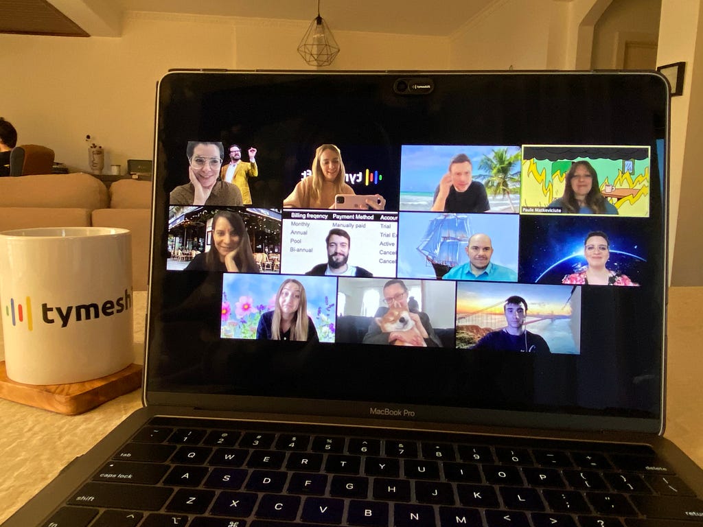 A laptop with small images of team members on a conference call.