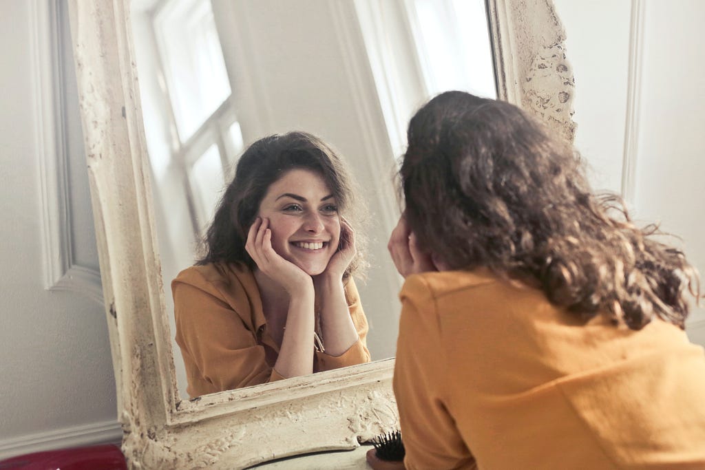 Girl smiling at her reflection