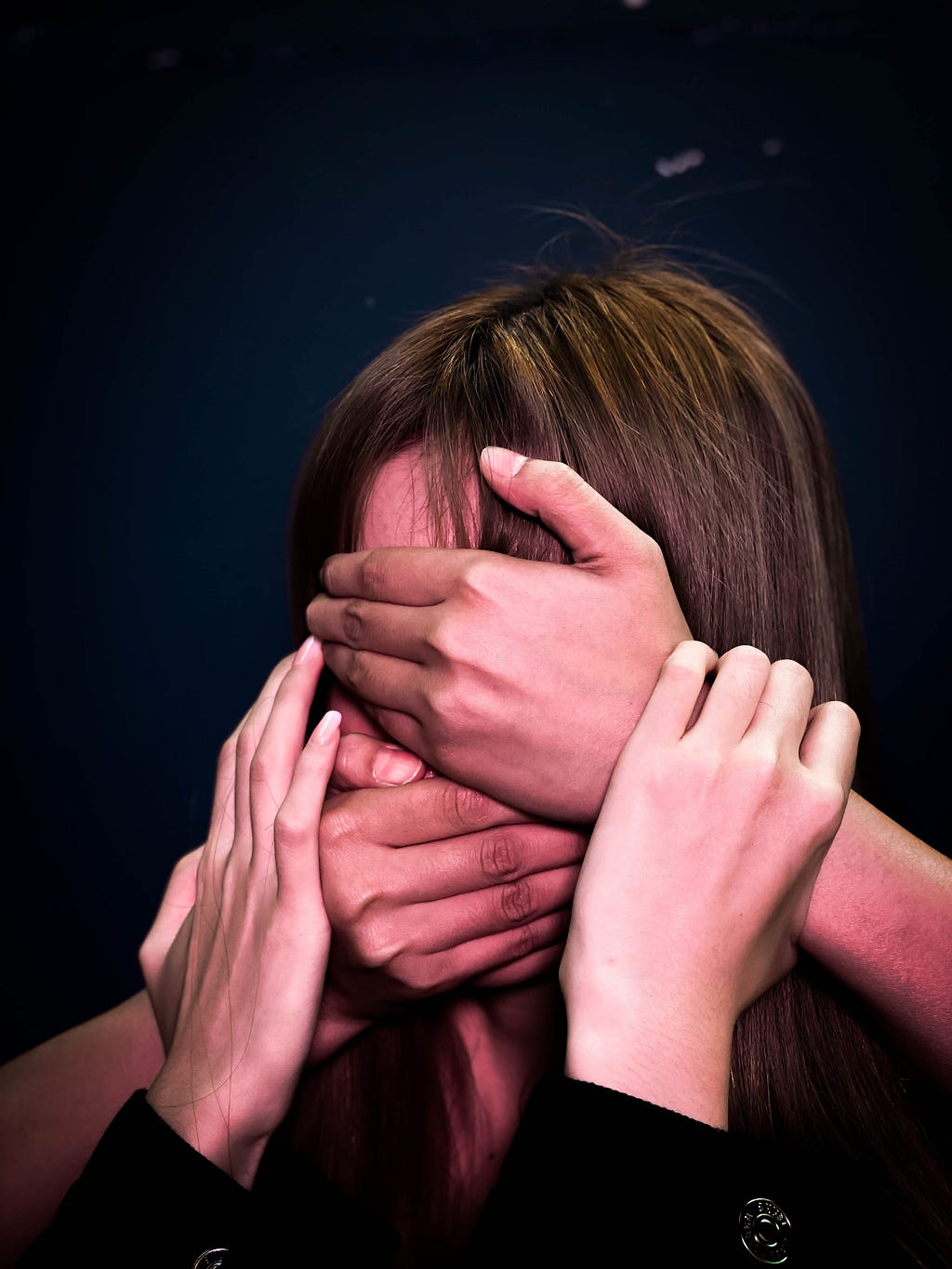 People covering face & mouth of woman