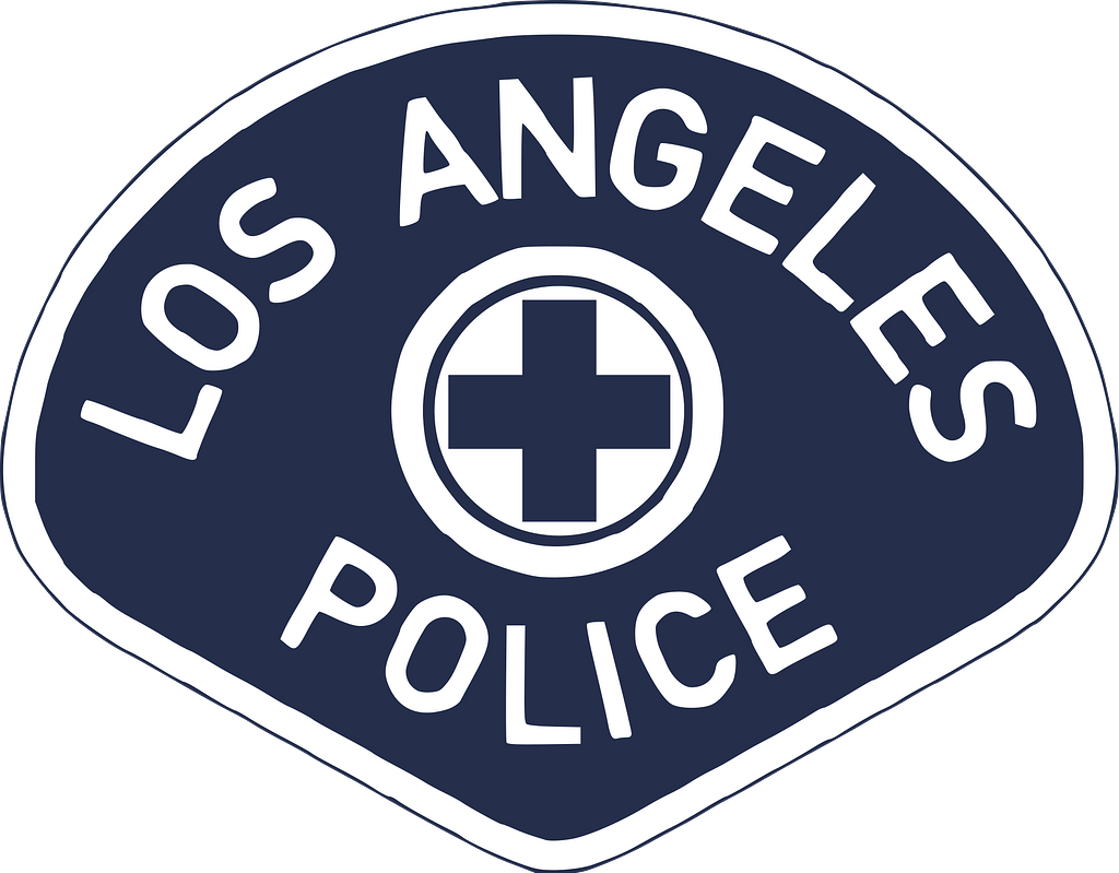 An illustrated image of the Los Angeles Police Department badge, white writing on a deep blue background. In the center of the badge is a blue plus sign outlined in a white circle.