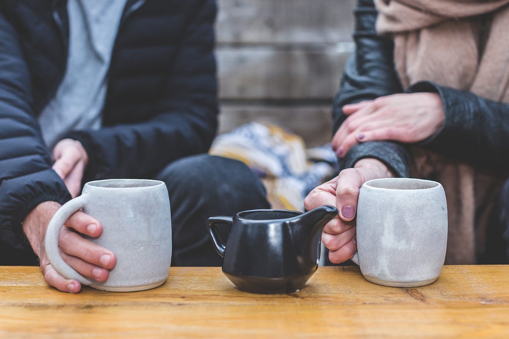 Image depicting two mugs and a coffee or tea pot