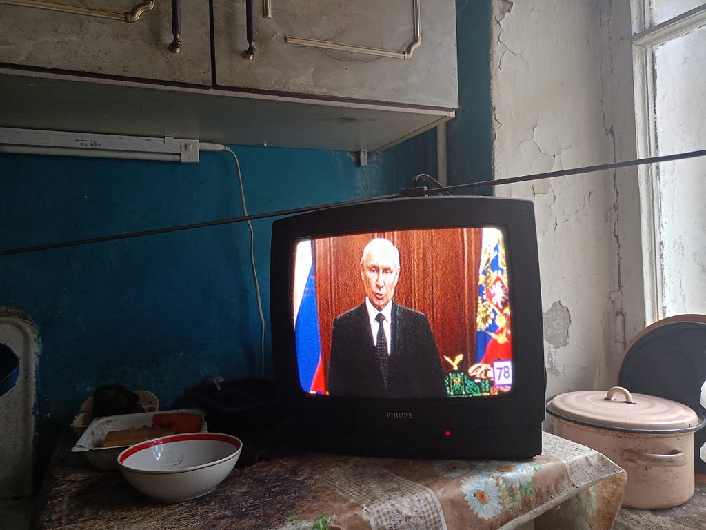 Vladimir Putin, President of Russia, is seen on TV as he addresses Russian citizens about PMC Wagner in June 2023.