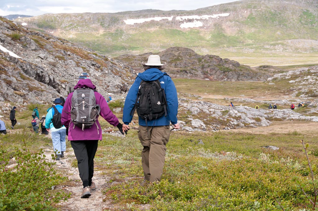 Passengers from Adventure Canada’s ship, Sea Adventurer, stroll along a path in St. John’s Bay in Labrador in northeastern Canada.