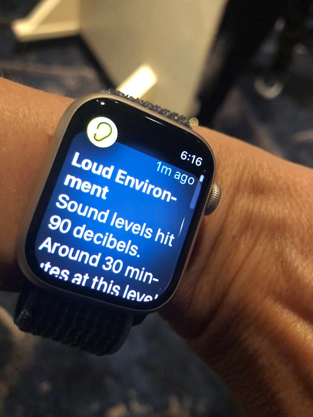 Closeup of smart watch displaying the warning: “Loud Environment-Sound levels hit 90 decibels. Around 30 minutes at this level…”