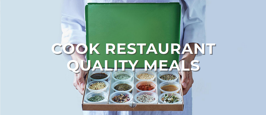 Torso of a man in chef whites proffering an open cardboard box, briefcase-style, that show 12 different coloured powders and herbs. The words Cook Restaurant quality meals in white text superimposed on the photo.
