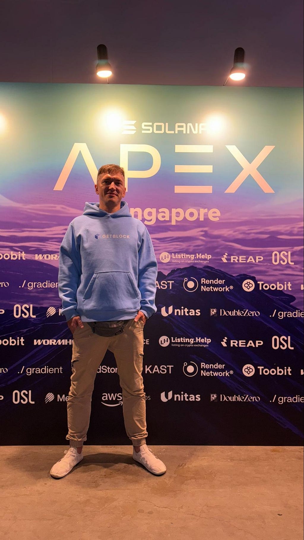 GetBlock CEO Vasily Rudomanov and a conference banner