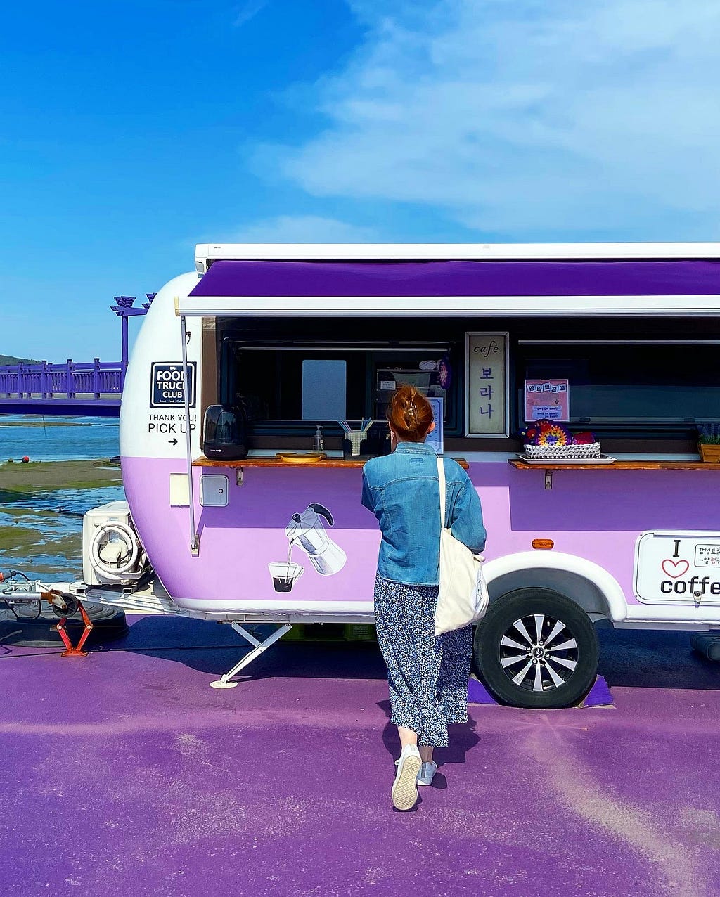 My friend is getting coffee at the purple coffee truck.