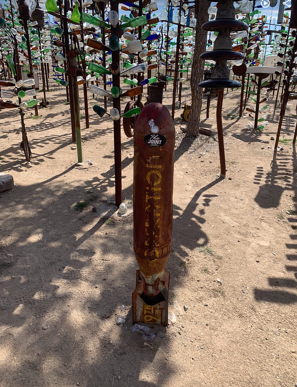 Rusted war bomb standing vertially at Elmer Long’s Bottle Ranch