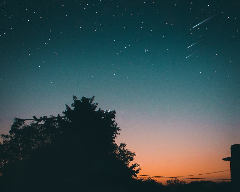 Dawn picture with meteors and stars, with a tree at the bottom