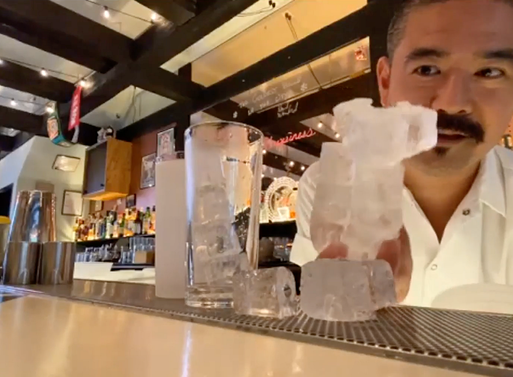 Photo of Masa preparing ice cubes for a cocktail.