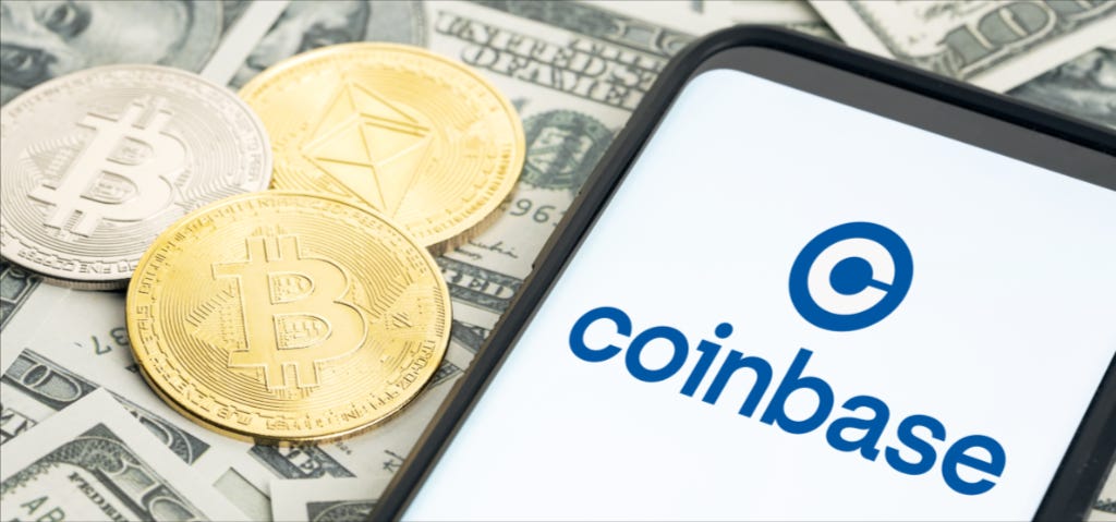 Coinbase logo on cell phone with crypto coins and US bills