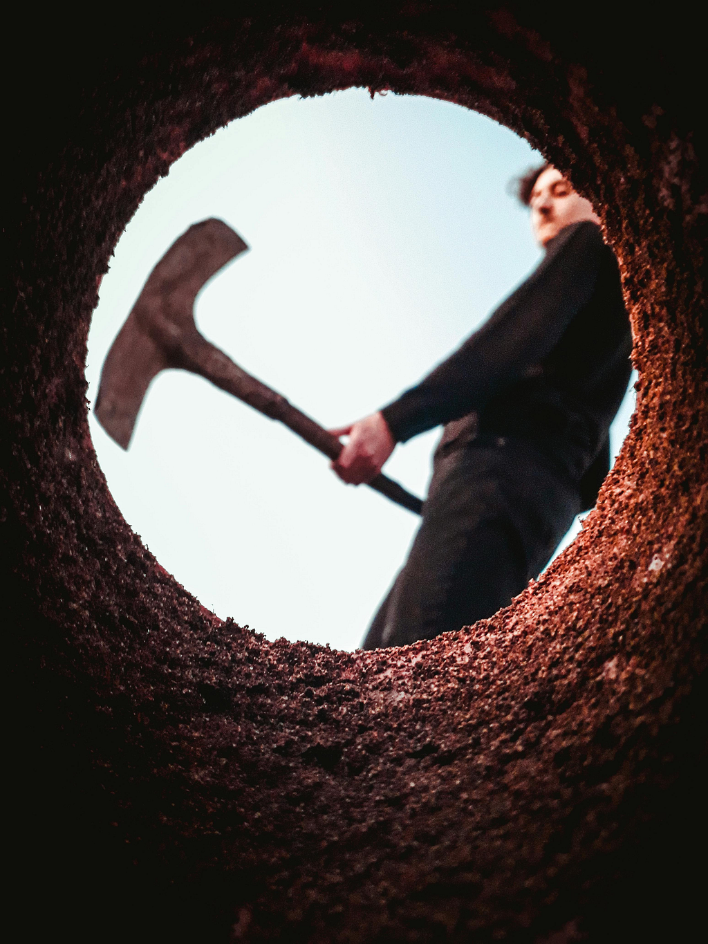 Photo from well of man digging a hole