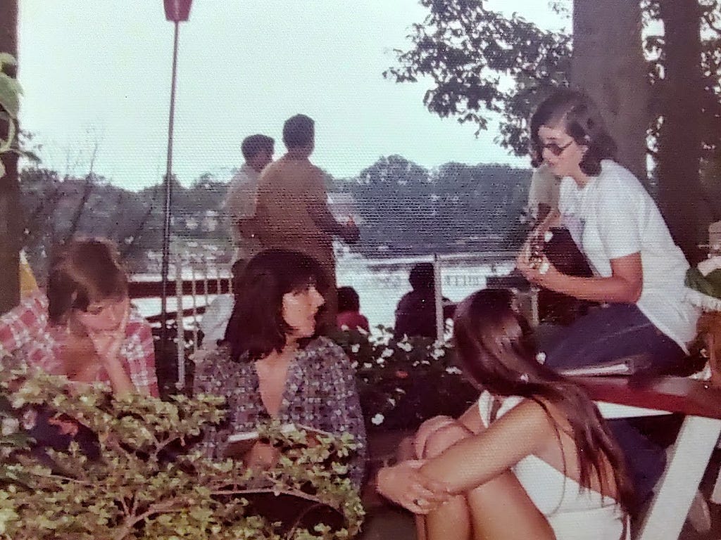 picture of me playing guitar to a small audience on July 4, 1974