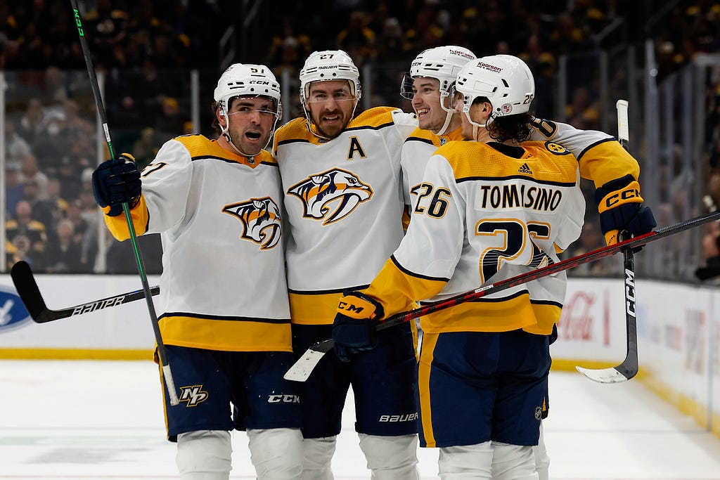 Mar 28, 2023; Boston, Massachusetts, USA; Nashville Predators center Cody Glass (8) (second from right) is congratulated by defenseman Dante Fabbro (57), defenseman Ryan McDonagh (27) and center Philip Tomasino (26) after scoring against the Boston Bruins during the second period at TD Garden. Credit: Winslow Townson-USA TODAY Sports