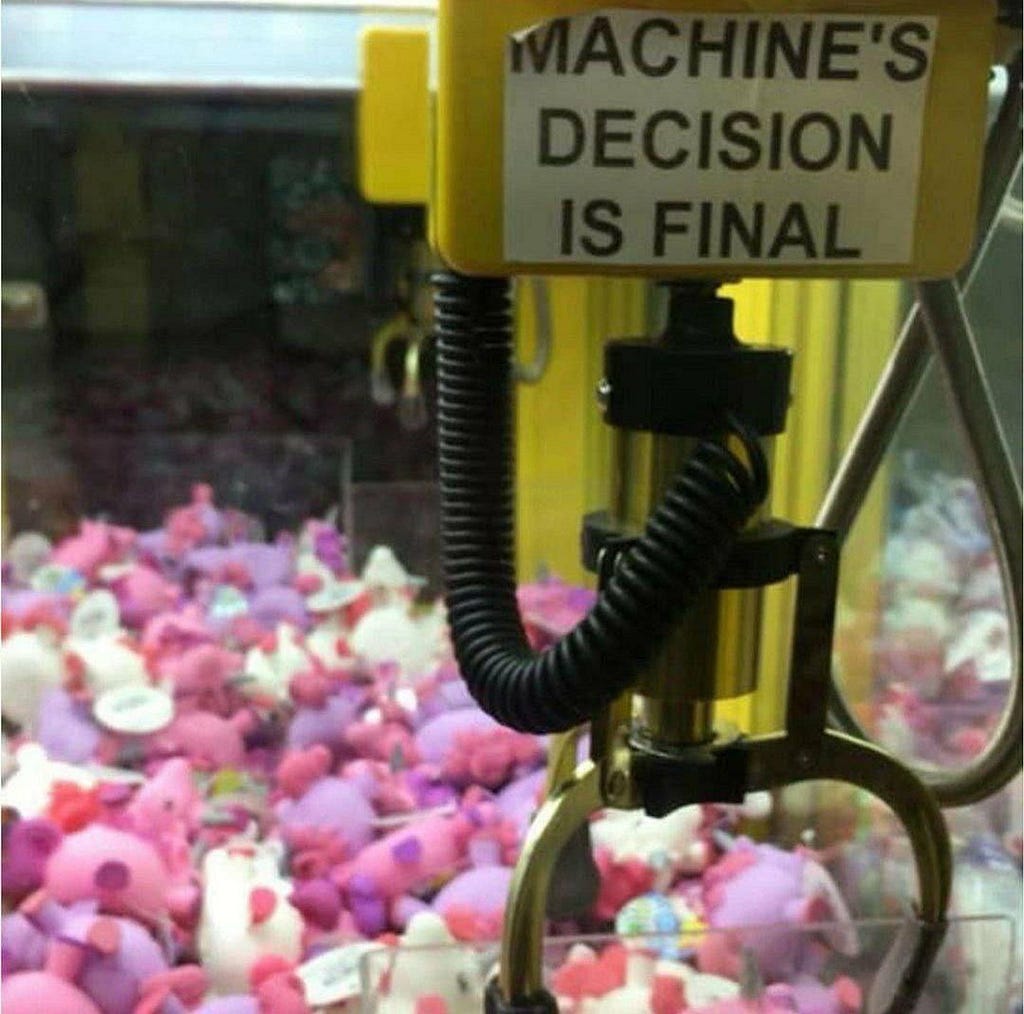 A claw machine that says “machine’s decision is final” on it.