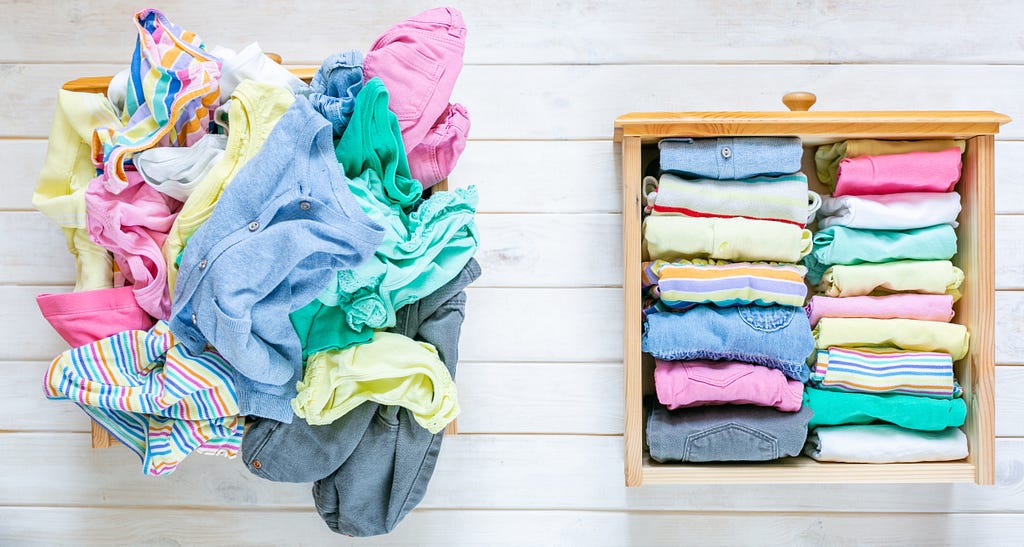 Image of clothes in a pile on the left, neatly folded clothes on the right