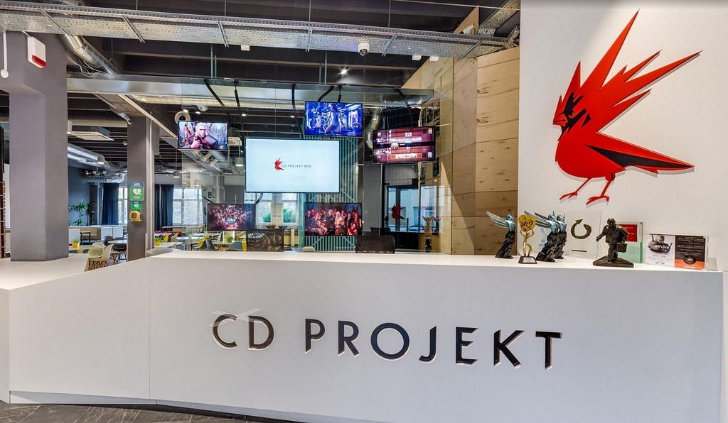 Entrance to one of CD Projekt Red’s studios, complete with iconic red logo and a display of figurines.