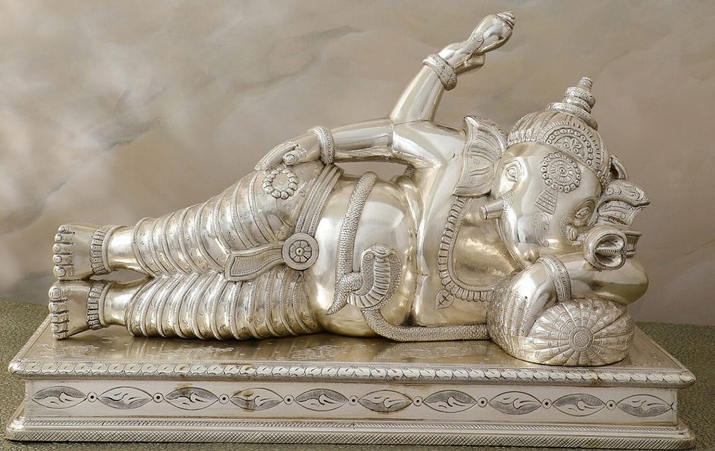 Explore the Tranquil Silver Reclining Ganesha Idol — Embodiment of Peace