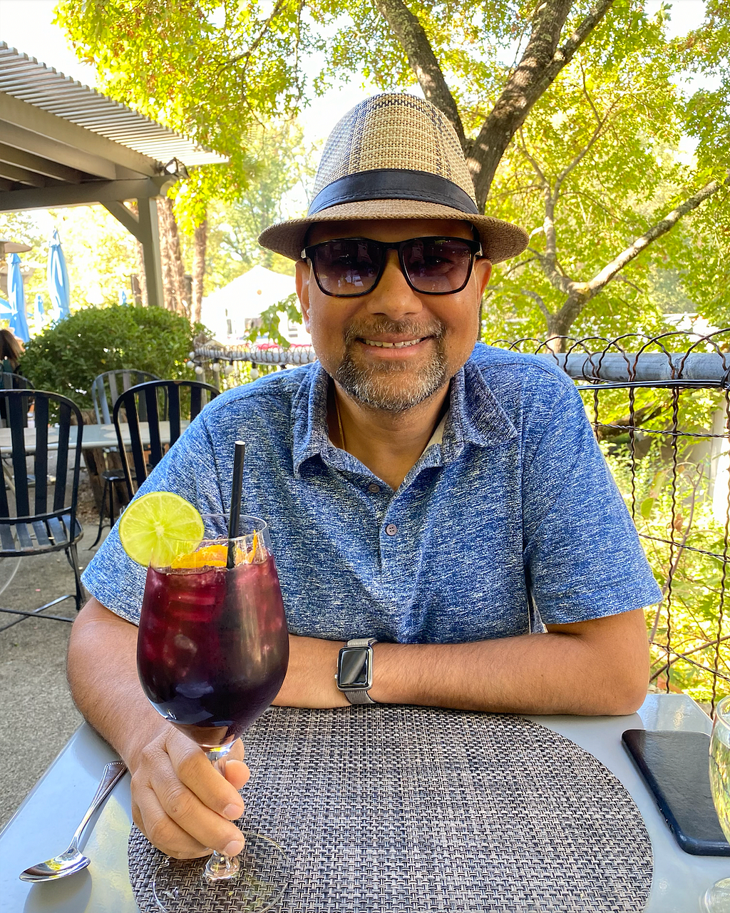 Dad smiling at mom while drinking Sangria in his beloved fedora.