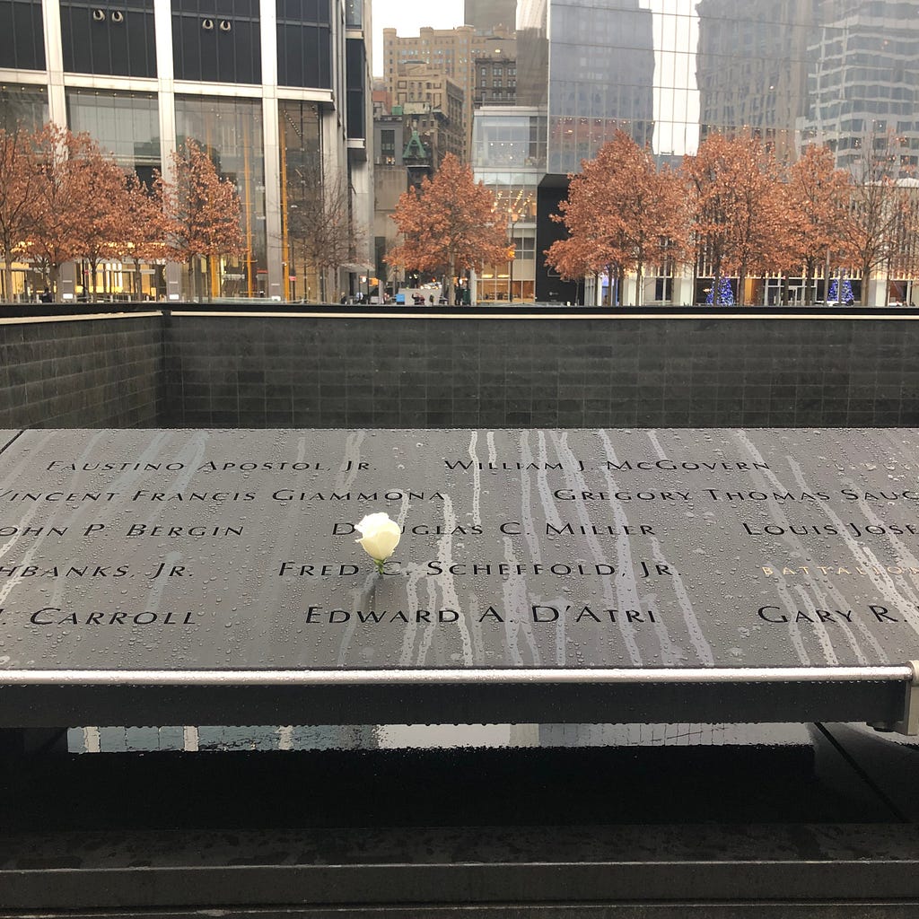 Photo of my father’s name at the 9/11 Memorial with a rose, placed on his birthday.