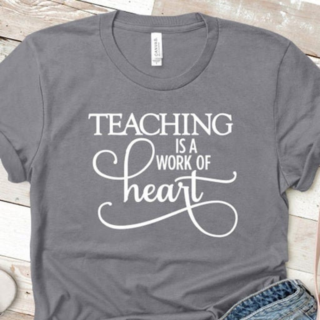 A gray t-shirt emblazoned with the phrase, “Teaching is a work of heart.”