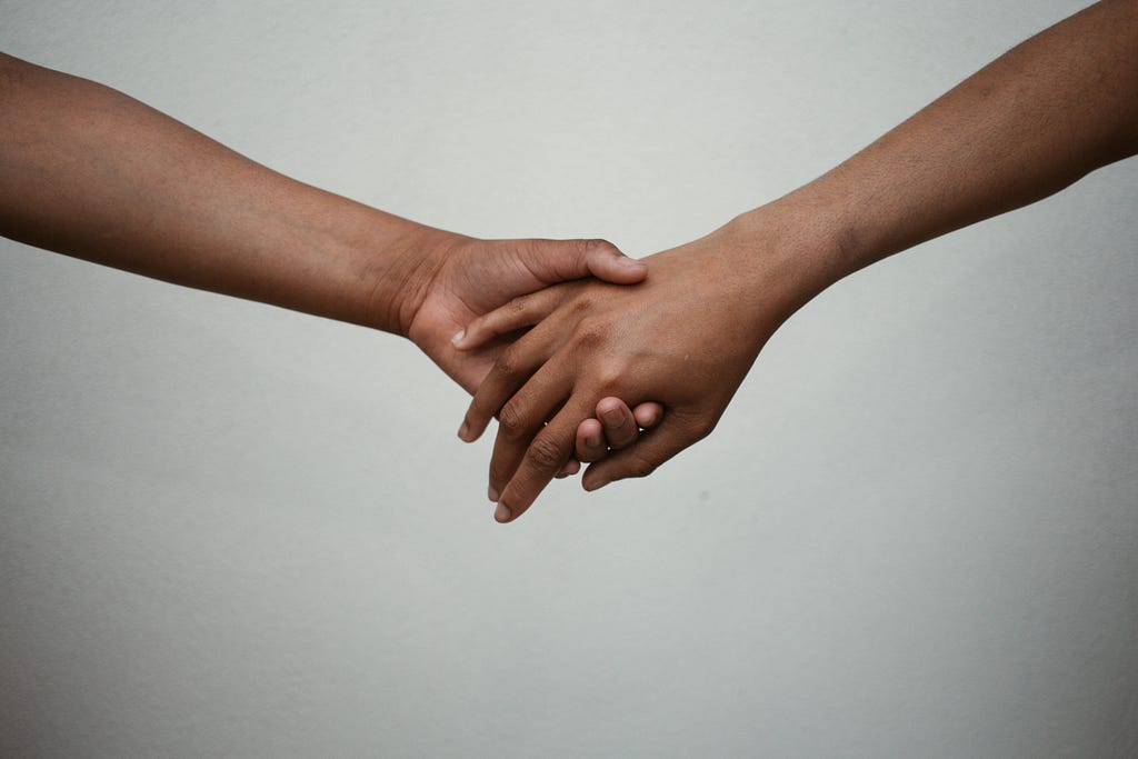 people holding hands for mental health