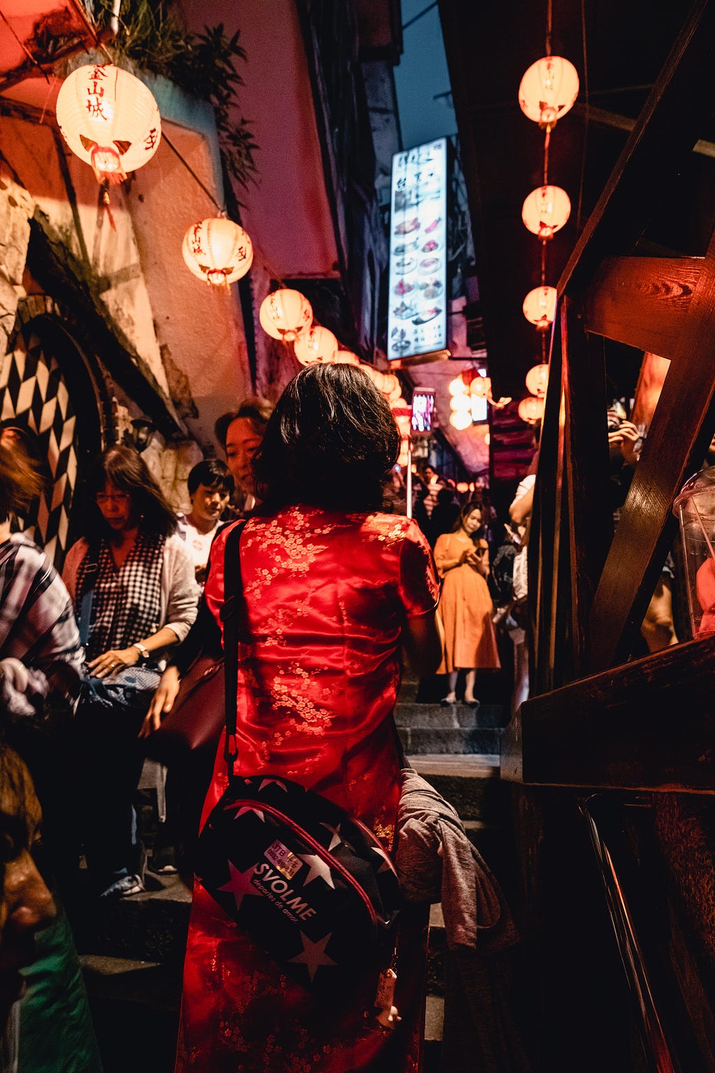 lady in asian red dress in street filled with lanterns
