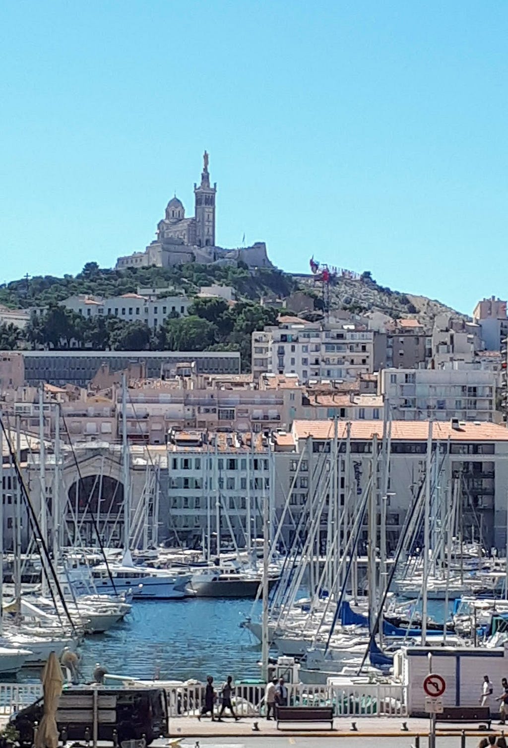 A photograph of the waterfront and a church in Marseille, France.