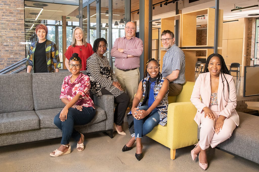 Colleagues from FSNet-Africa gather in a seating area to pose for a photograph