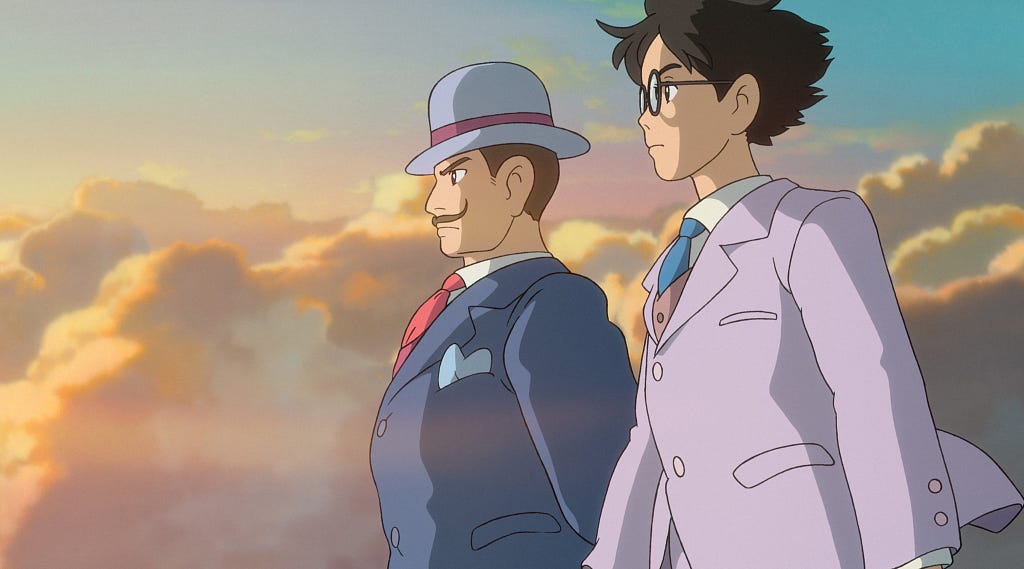 two men stare off into the distance with the sky of a sunset behind them