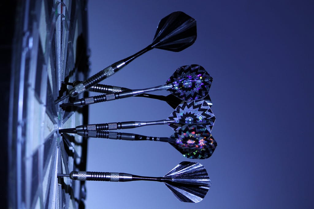 Darts stuck in a dartboard