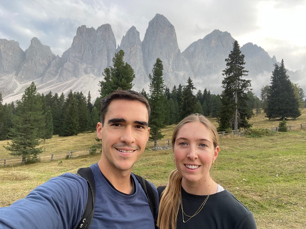Horea and woman standing in fromt of the Dolomites (Val de Funes)