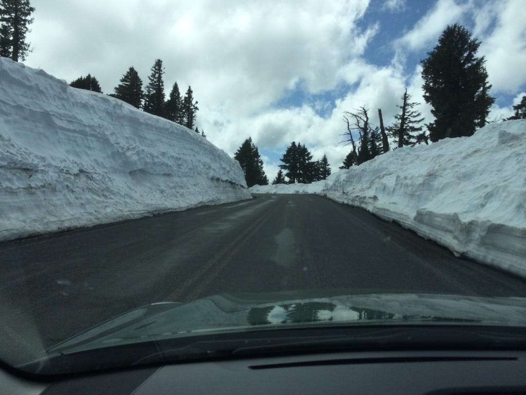 Road to Crater Lake Visitor Center in early spring with 10 feet of plowed snow.